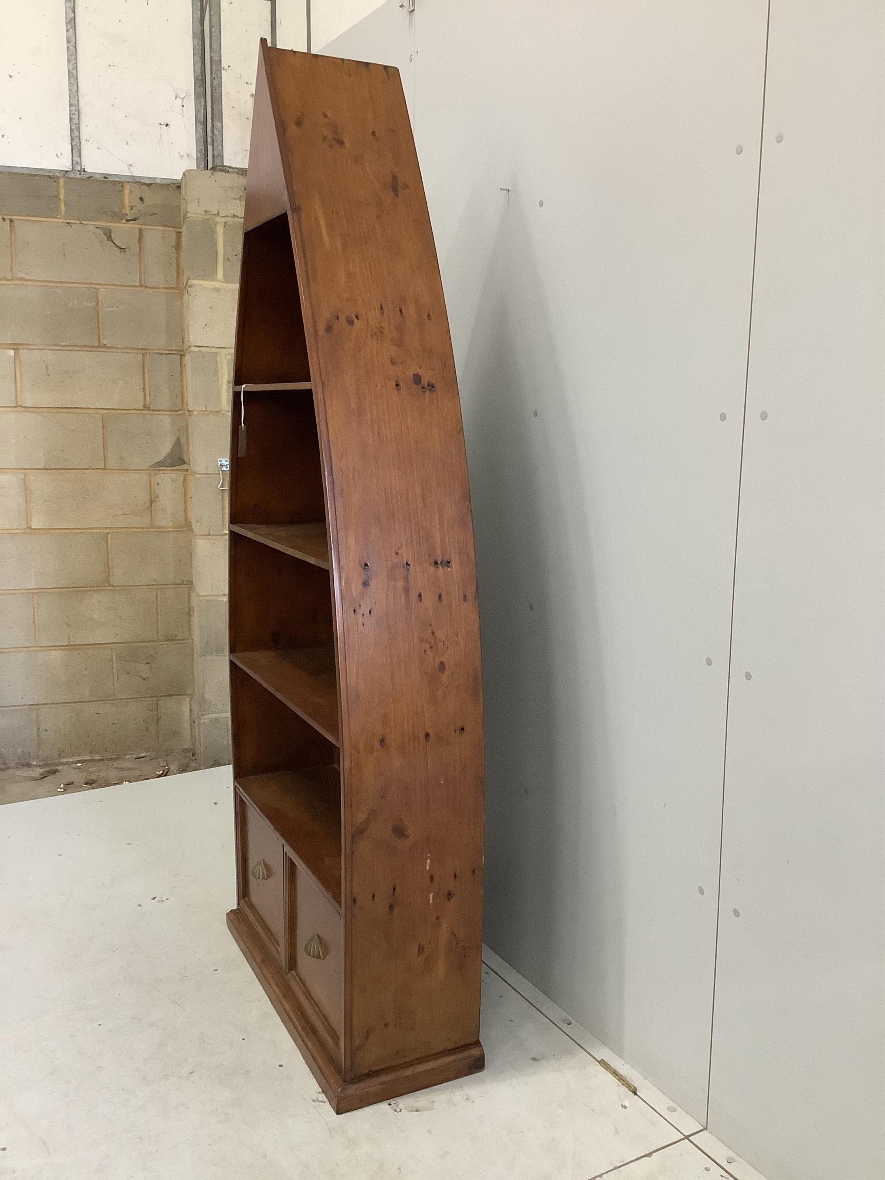 A reproduction Barker and Stonehouse hardwood boat shaped two drawer bookcase, width 83cm, depth 32cm, height 204cm. Condition - fair to good